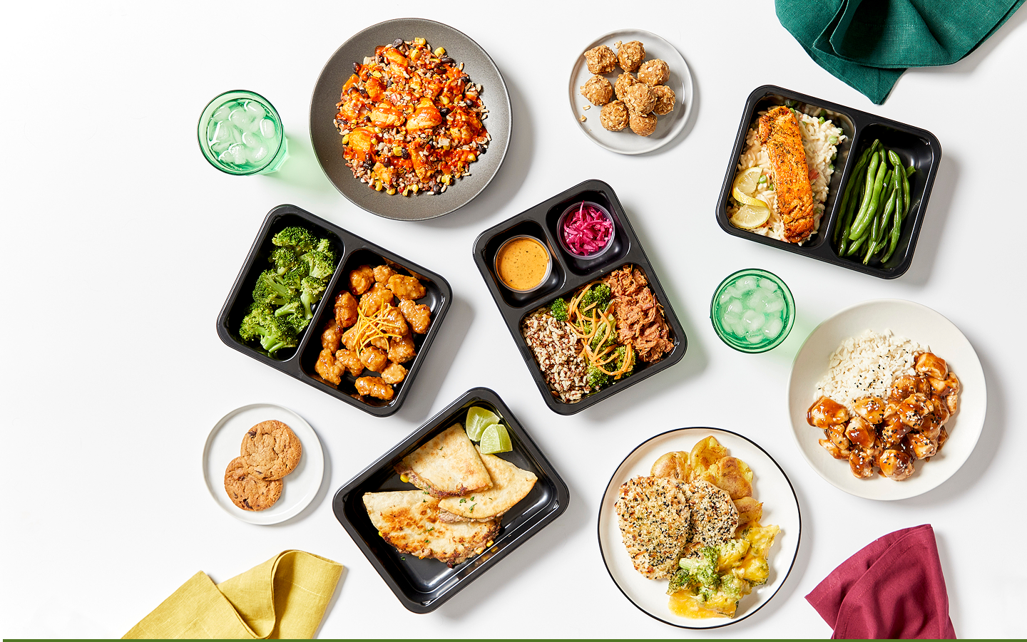 Chef-prepared meals, bowls and containers arranged on a table